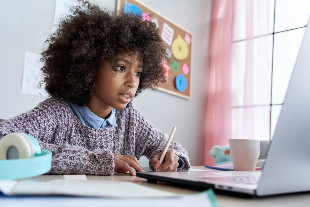 A student working on a laptop at home